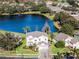 House on a lake with a large backyard and surrounding homes at 9657 Pacific Pines Ct, Orlando, FL 32832