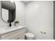 Modern bathroom with white vanity, black faucet, and an oval mirror at 9657 Pacific Pines Ct, Orlando, FL 32832