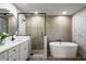 Spa-like bathroom with double vanity, a freestanding tub and walk-in shower at 9657 Pacific Pines Ct, Orlando, FL 32832