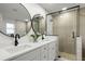 Elegant bathroom with double vanity, large mirrors, and a walk-in shower at 9657 Pacific Pines Ct, Orlando, FL 32832