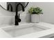 Close-up of a modern bathroom vanity with black faucet and white countertop at 9657 Pacific Pines Ct, Orlando, FL 32832