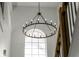 Close-up view of a beautiful chandelier in the entryway at 9657 Pacific Pines Ct, Orlando, FL 32832