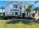 Two-story house with a three-car garage and lush landscaping at 9657 Pacific Pines Ct, Orlando, FL 32832