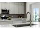 Modern kitchen with a sleek faucet and white counters at 9657 Pacific Pines Ct, Orlando, FL 32832