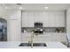 Modern kitchen with white cabinets and a center island at 9657 Pacific Pines Ct, Orlando, FL 32832