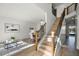 Modern staircase with wooden handrail and metal balusters at 9657 Pacific Pines Ct, Orlando, FL 32832