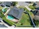 Aerial view of a home with a backyard pool and lush green lawn in a desirable neighborhood at 1003 Beckstrom Dr, Oviedo, FL 32765