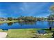 Scenic pond view with seating areas and lush landscaping, perfect for relaxation at 1003 Beckstrom Dr, Oviedo, FL 32765