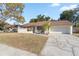 Single-story house with brown roof, red door, and landscaped front yard at 1163 Queen Elaine Dr, Casselberry, FL 32707