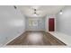 Spacious living room with wood-look flooring and high ceilings at 1163 Queen Elaine Dr, Casselberry, FL 32707