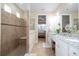 Elegant bathroom featuring a double vanity and walk-in shower at 12088 Uleta Ln, Orlando, FL 32827