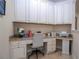 L shaped desk with granite countertop and white cabinets at 12088 Uleta Ln, Orlando, FL 32827