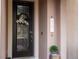 Dark front door with glass inserts and wreath at 12088 Uleta Ln, Orlando, FL 32827
