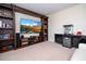 Home theater with large TV, built-in shelving, and wet bar at 12088 Uleta Ln, Orlando, FL 32827