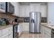 Modern kitchen with stainless steel appliances and white cabinets at 12088 Uleta Ln, Orlando, FL 32827