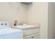 Clean laundry room with a utility sink and overhead shelving at 12088 Uleta Ln, Orlando, FL 32827