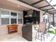 Outdoor kitchen with granite countertop and stainless steel appliances at 12088 Uleta Ln, Orlando, FL 32827