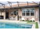 Pool and spa with outdoor kitchen and seating area at 12088 Uleta Ln, Orlando, FL 32827