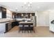 Modern kitchen with dark wood cabinets, granite countertops and stainless steel appliances at 131 Cambria Grove Cir, Davenport, FL 33837