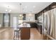 Modern kitchen with dark cabinets, granite counters, island with seating and access to backyard at 131 Cambria Grove Cir, Davenport, FL 33837