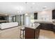 Open floor plan with kitchen island, granite counters, and living area at 131 Cambria Grove Cir, Davenport, FL 33837