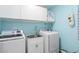Bright laundry room with washer, dryer, and cabinets at 131 Cambria Grove Cir, Davenport, FL 33837