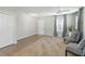 Bright living room with neutral decor, tiled floor, and access to entryway at 131 Cambria Grove Cir, Davenport, FL 33837