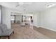 Open living room with neutral carpeting and access to other rooms at 131 Cambria Grove Cir, Davenport, FL 33837