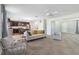Open living area with modern furniture, kitchen views, and warm color palette at 131 Cambria Grove Cir, Davenport, FL 33837