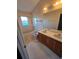 Clean bathroom with double sinks and a bathtub at 13823 Glasser Ave, Orlando, FL 32826