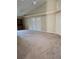 Large living room with carpeted floor and double doors at 13823 Glasser Ave, Orlando, FL 32826