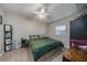 Bedroom with green bedding, ceiling fan, and laminate flooring at 1404 Adair St, Ocoee, FL 34761