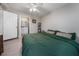 Bedroom with green bedding, ceiling fan, and ensuite bathroom at 1404 Adair St, Ocoee, FL 34761