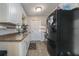 Kitchen with white cabinets, tile floors, and black appliances at 1404 Adair St, Ocoee, FL 34761