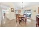 Dining area with a wooden table and chairs, leading to the kitchen at 1426 Spring Ridge Dr, Winter Garden, FL 34787