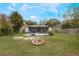Large backyard with covered patio and fire pit at 14528 Lycastle Cir, Orlando, FL 32826