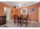 Small dining area with a dark wood table and orange walls at 14528 Lycastle Cir, Orlando, FL 32826