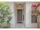 House entrance with a brown door and lush green plants at 14528 Lycastle Cir, Orlando, FL 32826
