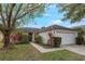 House exterior with attached garage and landscaping at 14528 Lycastle Cir, Orlando, FL 32826