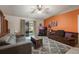 Spacious living room with a brown couch and a large TV at 14528 Lycastle Cir, Orlando, FL 32826