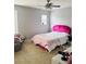 Bedroom with pink headboard and window coverings at 15269 Galbi Dr, Orlando, FL 32828