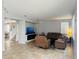 Spacious living room with brown reclining furniture and tile floors at 15269 Galbi Dr, Orlando, FL 32828