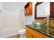 Classic bathroom featuring a vanity with glass vessel sink, tiled walls, and a standard bathtub with shower at 1633 Corner Meadow Cir, Orlando, FL 32820