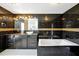Luxurious bathroom featuring a black marble tile, modern vanity, soaking tub, and elegant lighting fixtures at 1633 Corner Meadow Cir, Orlando, FL 32820