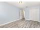 Neutral bedroom with wood-look floors, neutral paint, closet and doorway at 1633 Corner Meadow Cir, Orlando, FL 32820