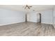 Spacious room features neutral paint and modern wood-look floors with an arched doorway, providing access to other parts of the house at 1633 Corner Meadow Cir, Orlando, FL 32820