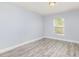 Light-filled bedroom with new wood-look flooring, neutral paint, and bright natural light at 1633 Corner Meadow Cir, Orlando, FL 32820