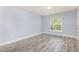 Inviting bedroom with light blue walls, modern wood-look flooring and a large window offering natural light at 1633 Corner Meadow Cir, Orlando, FL 32820