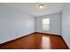 Spacious bedroom with hardwood floors and a large window, offering ample natural light at 1633 Corner Meadow Cir, Orlando, FL 32820