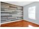 Bright bedroom with wood-look floors and an accent wall at 1633 Corner Meadow Cir, Orlando, FL 32820